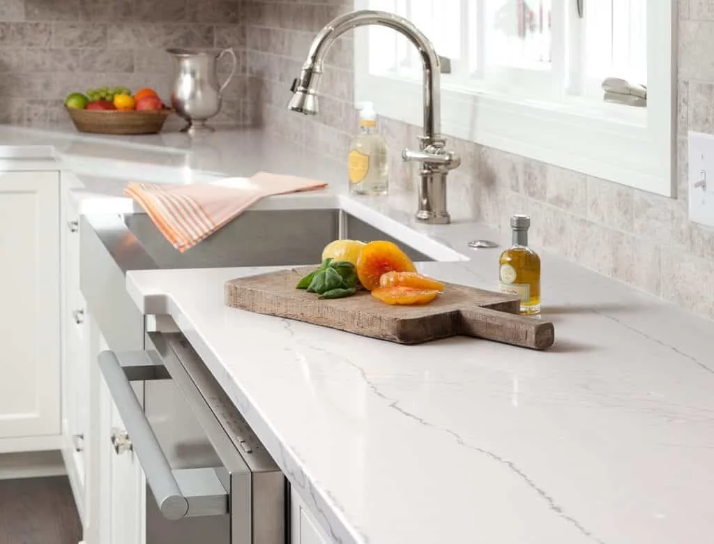 White quartz kitchen countertops with cutting board and sink