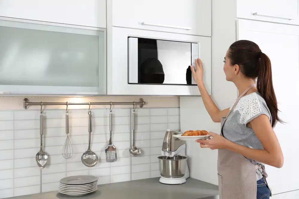 Woman making microwave snacks