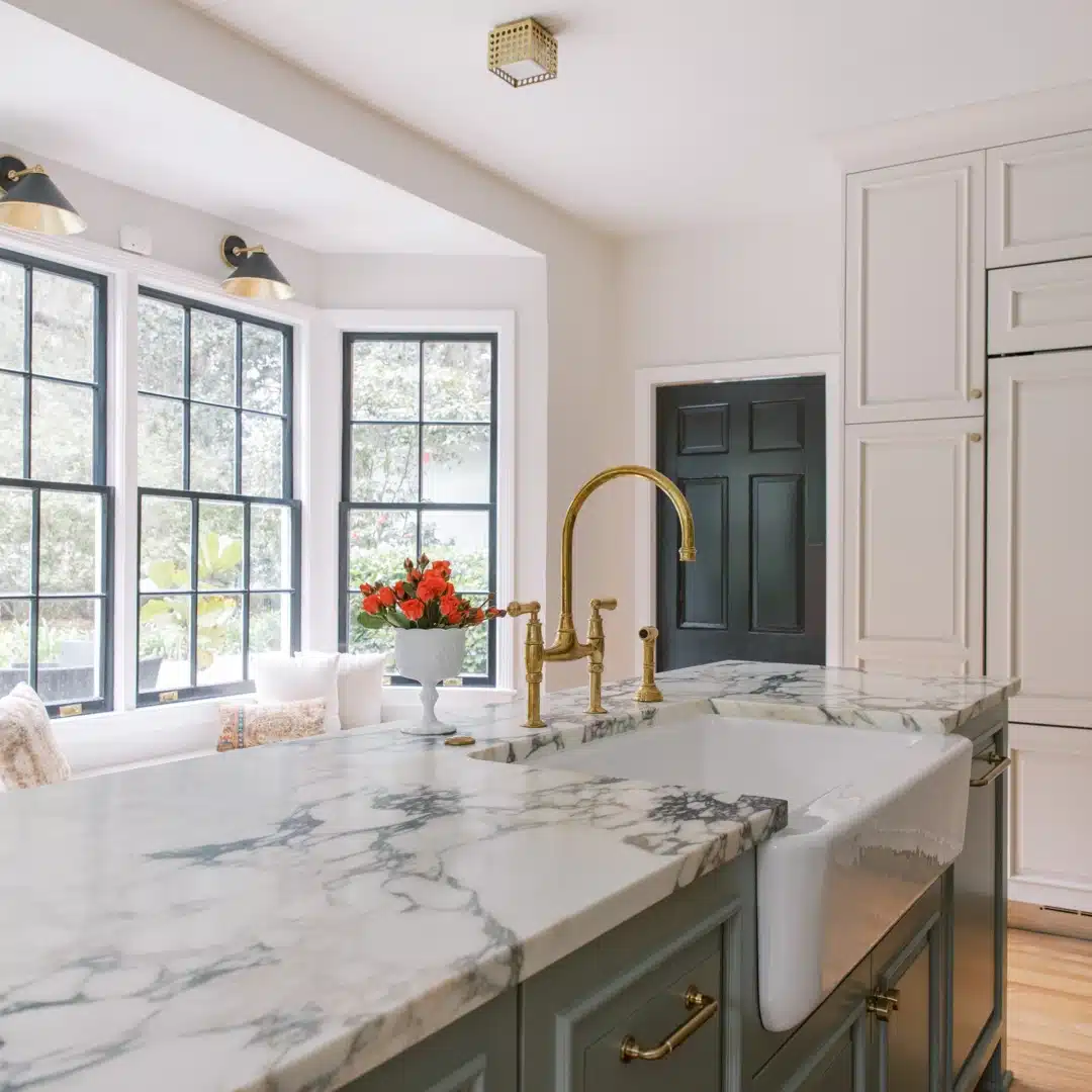 Kitchen Sink - farmhouse sink set in marble countertop with brass faucet