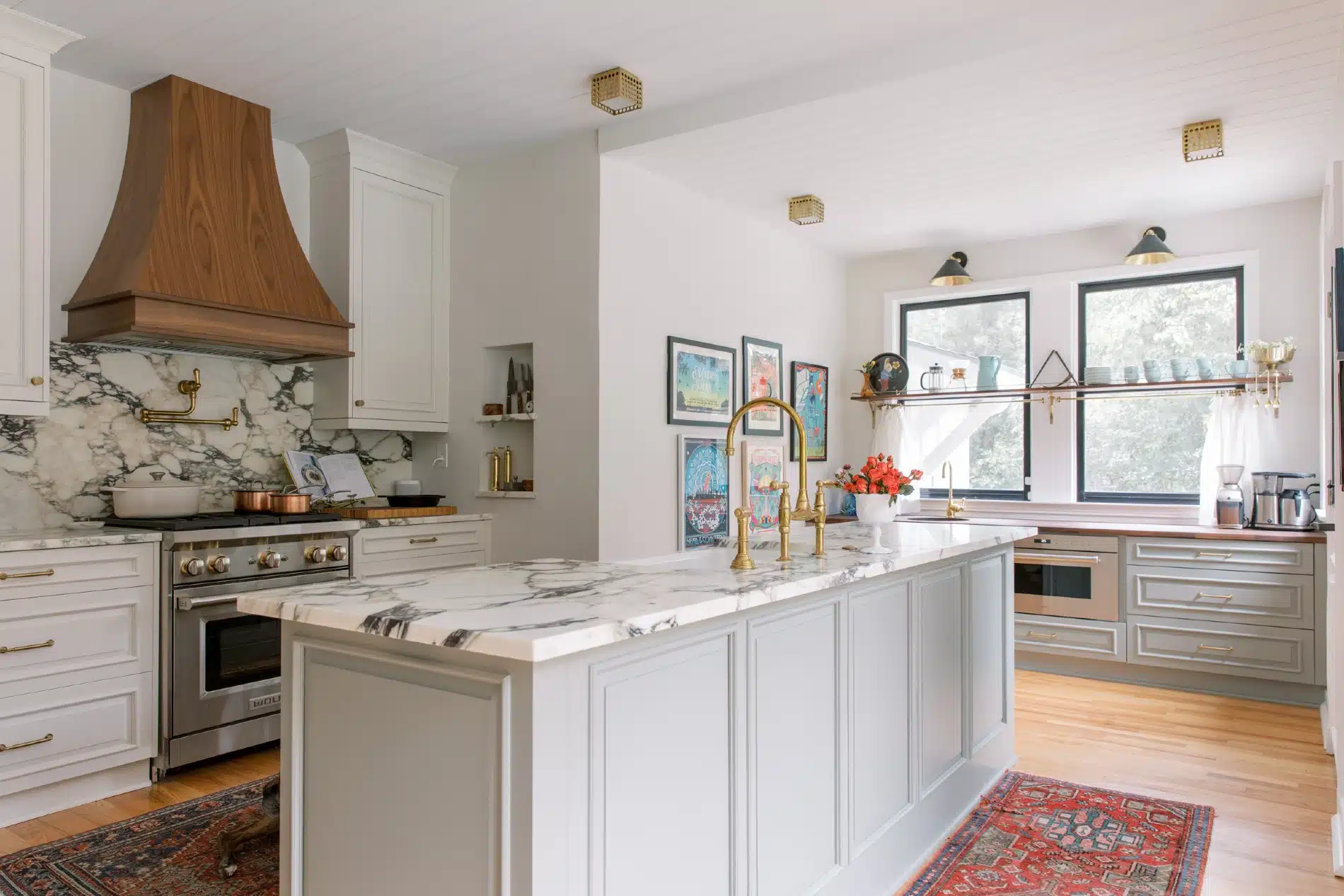 Chef's kitchen with walnut hood, marble counters and unlacquered brass fixtures