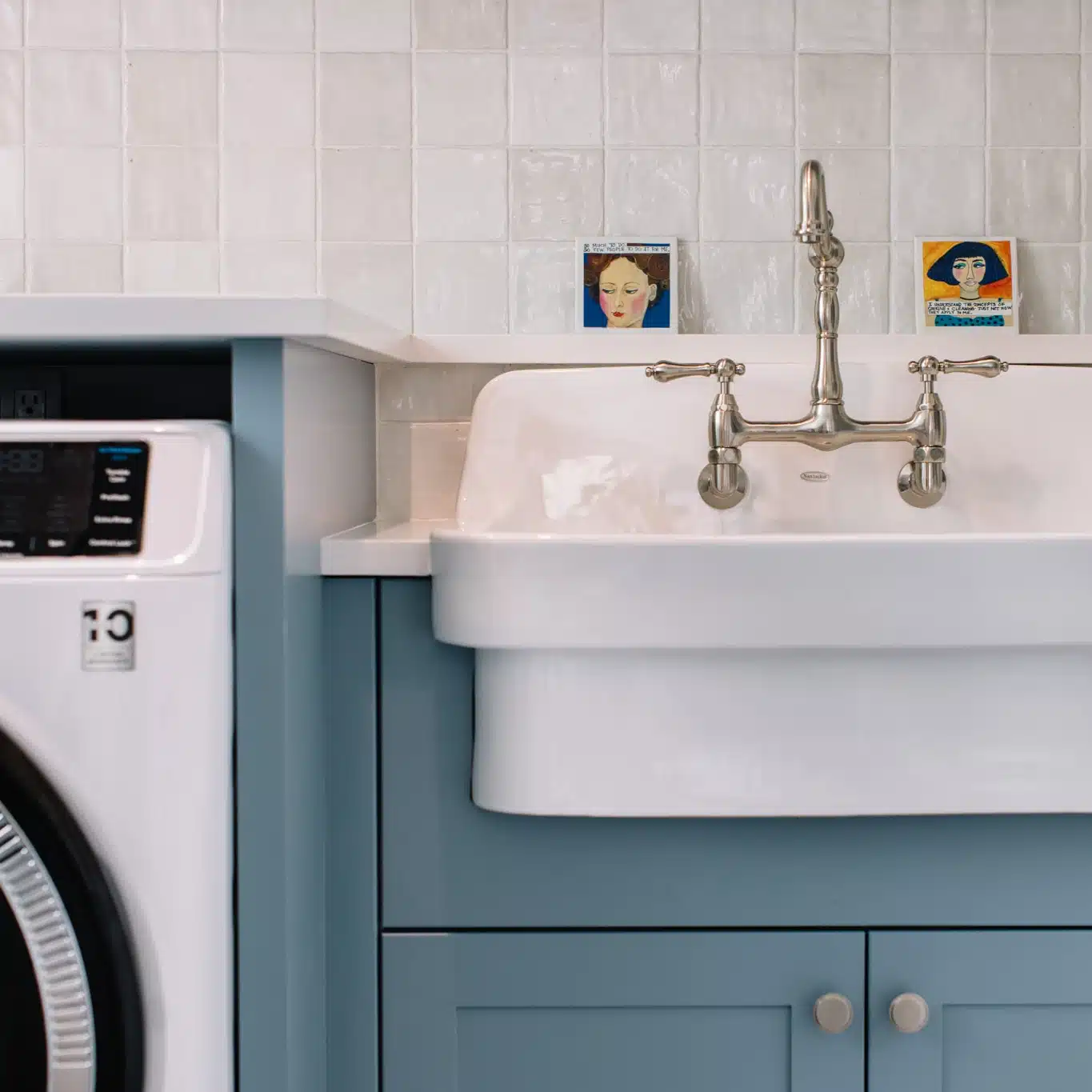Blue Laundry cabinets with vintage farm sink and faucet