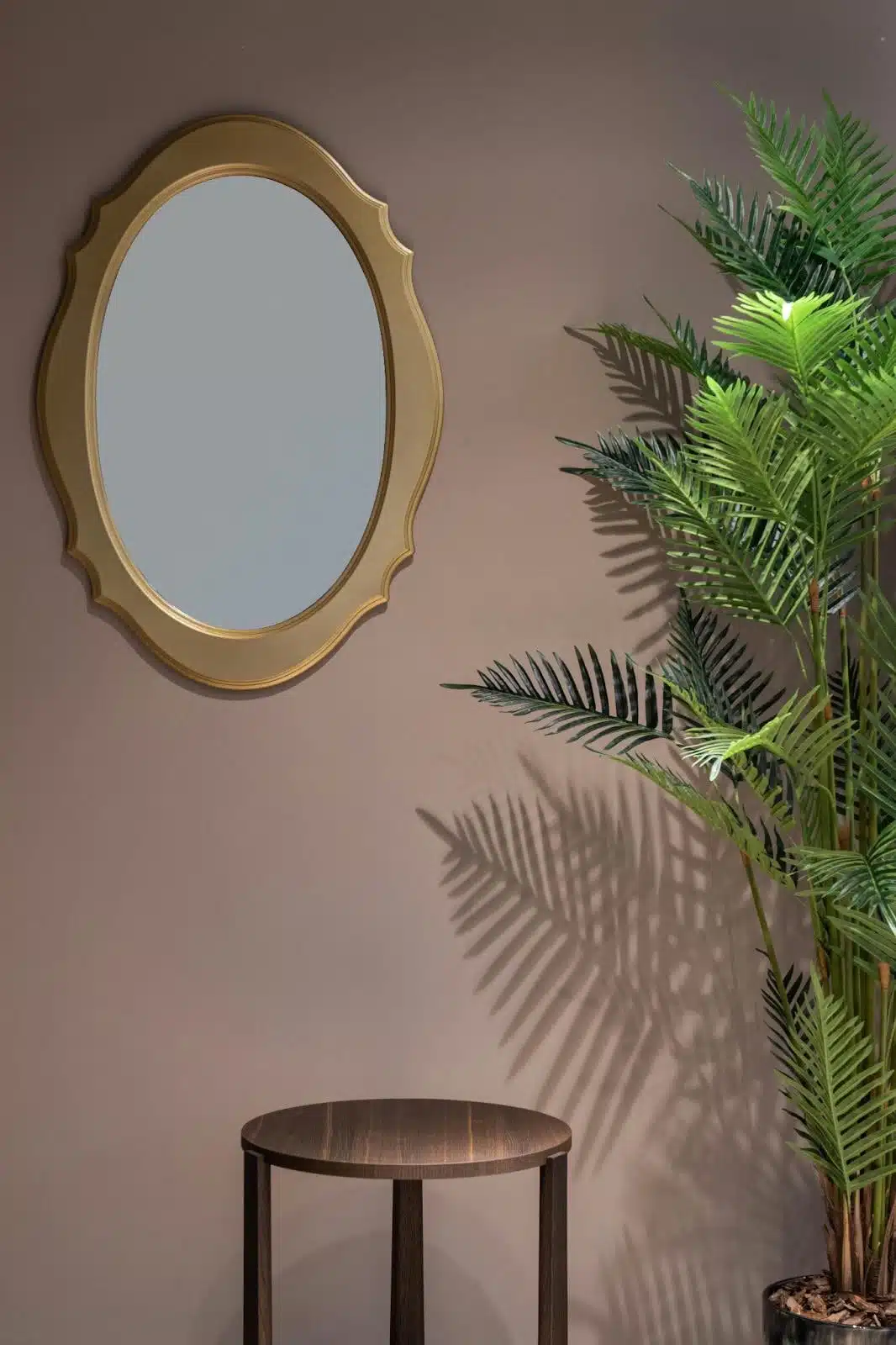 Room with potted plant near mirror and table