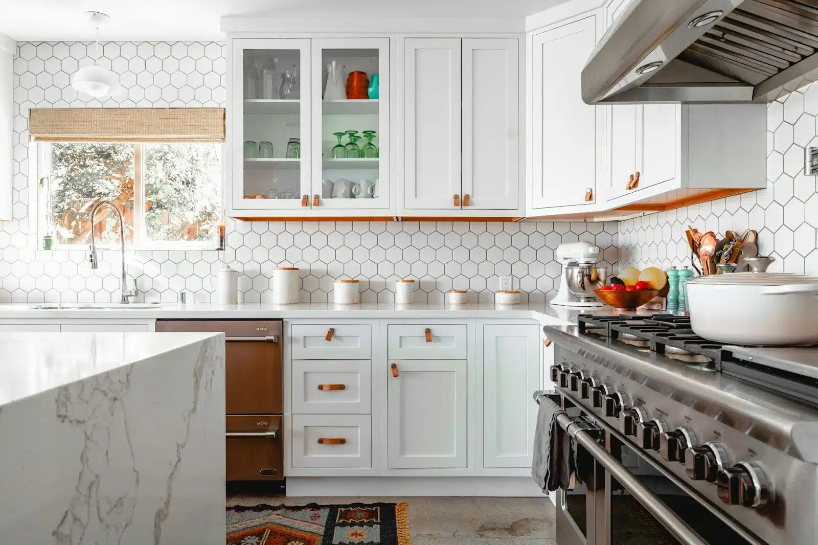 An organized kitchen with white counters.